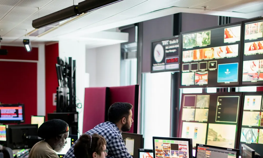 Operators monitoring screens in a control room